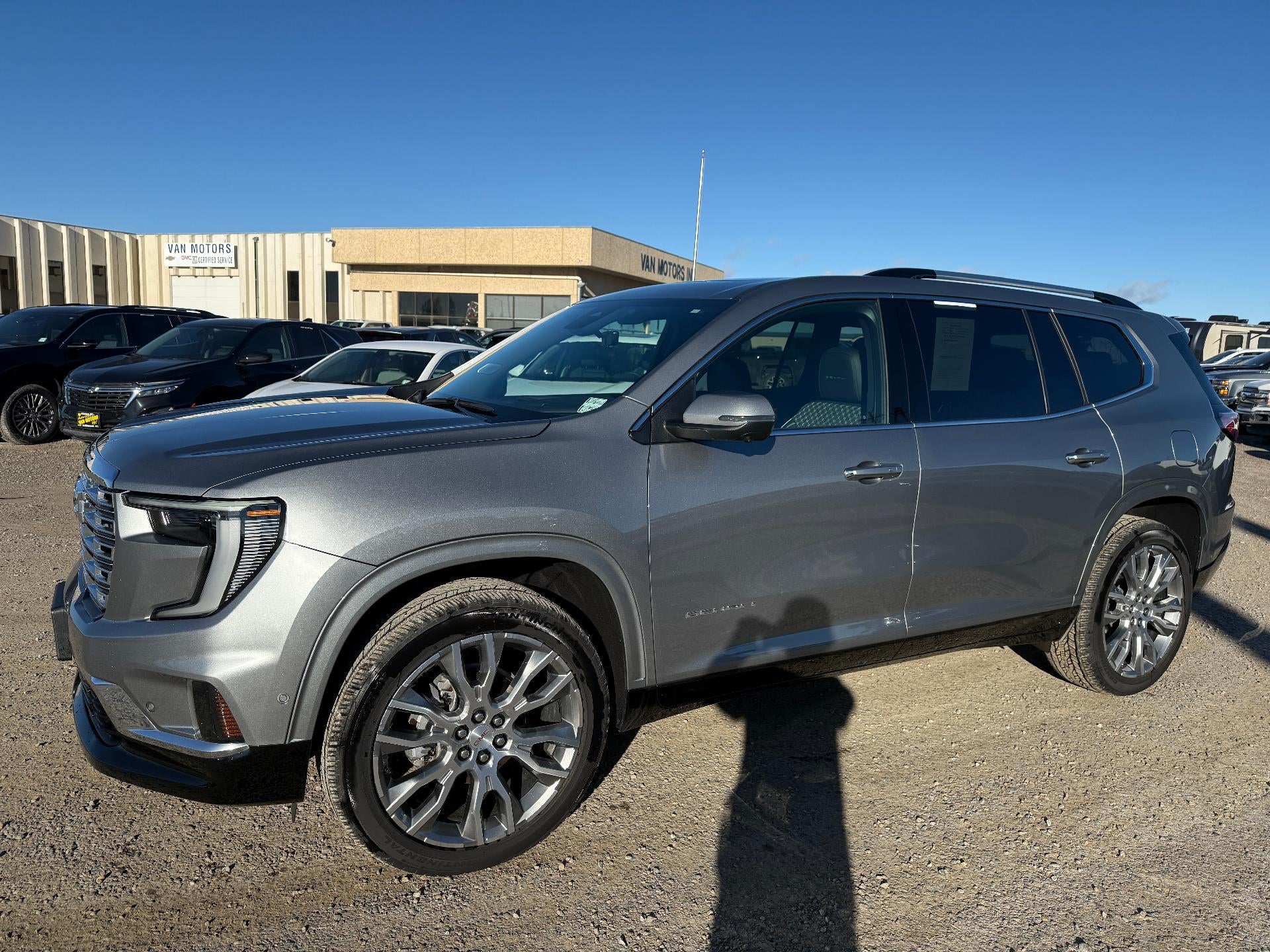 2024 GMC Acadia Denali in Sterling Metallic — front three-quarter view