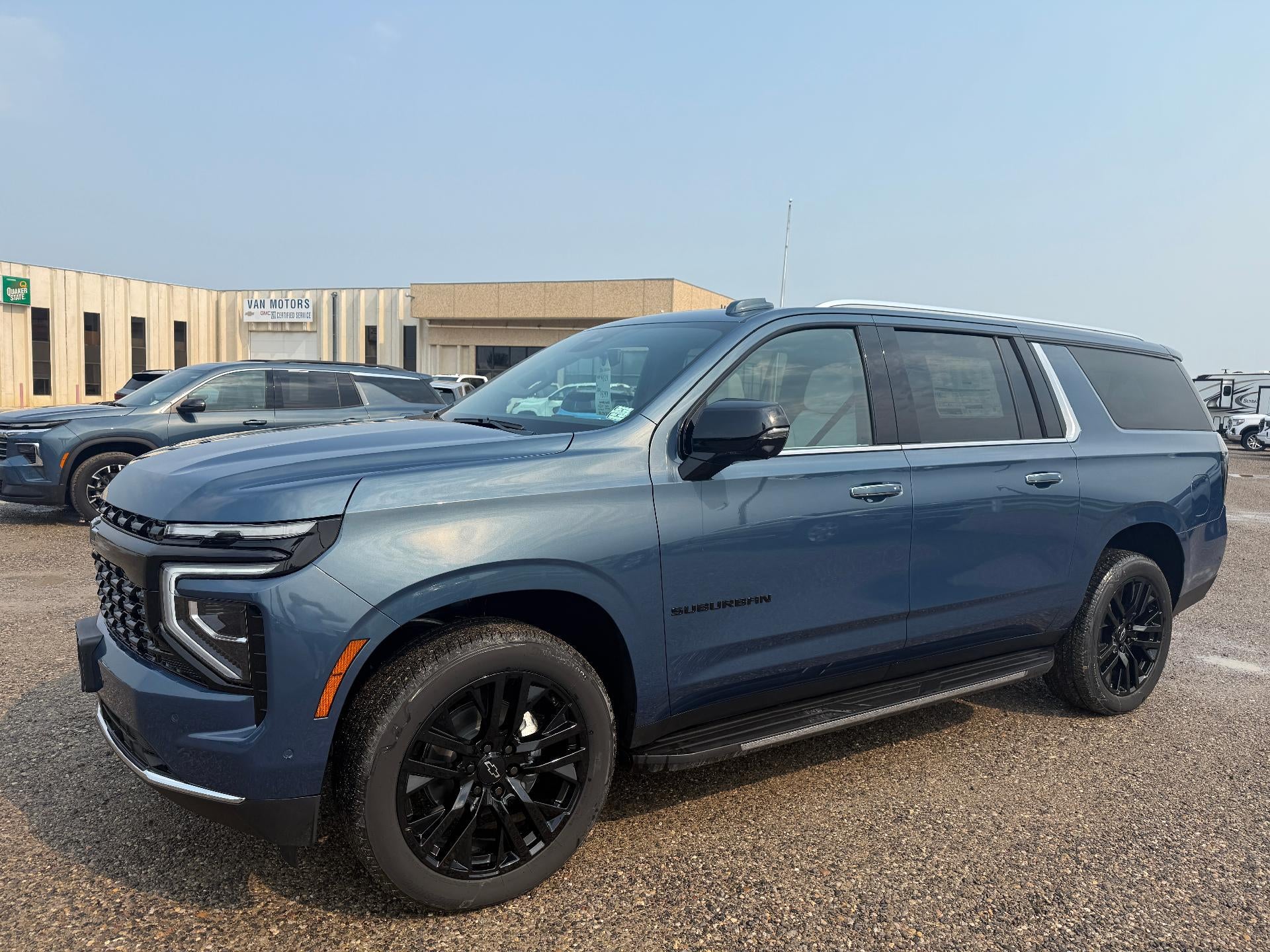 2026 Chevrolet Suburban Premier in Lakeshore Blue Metallic — front three-quarter view