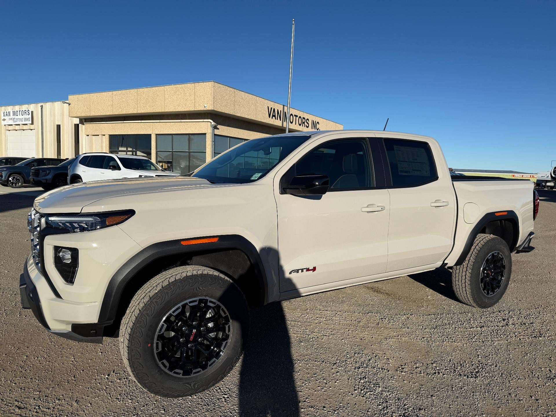 2026 GMC Canyon AT4 in Coastal Dune — front three-quarter view