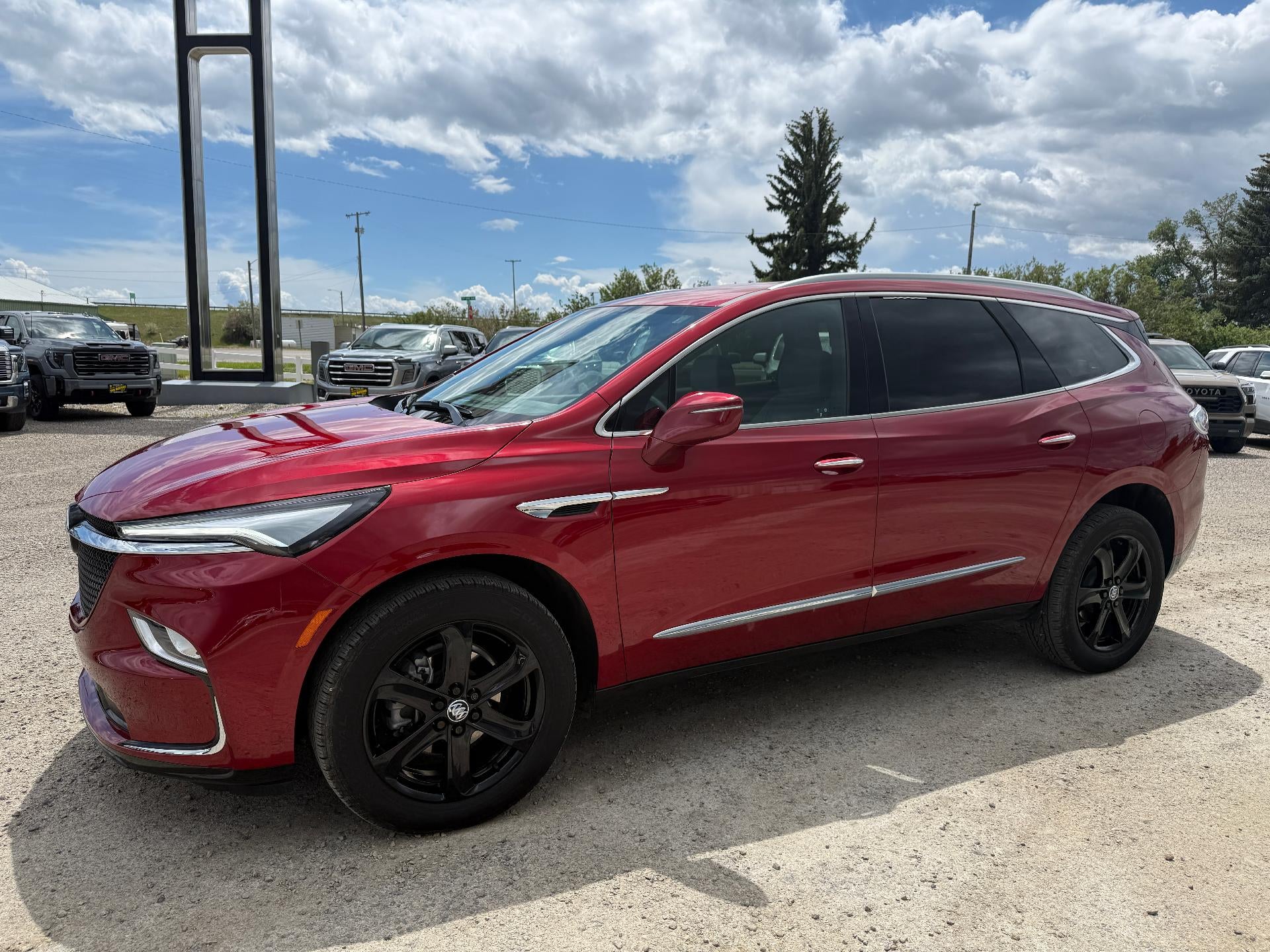 2024 Buick Enclave Essence in Cherry Red Tintcoat — front three-quarter view